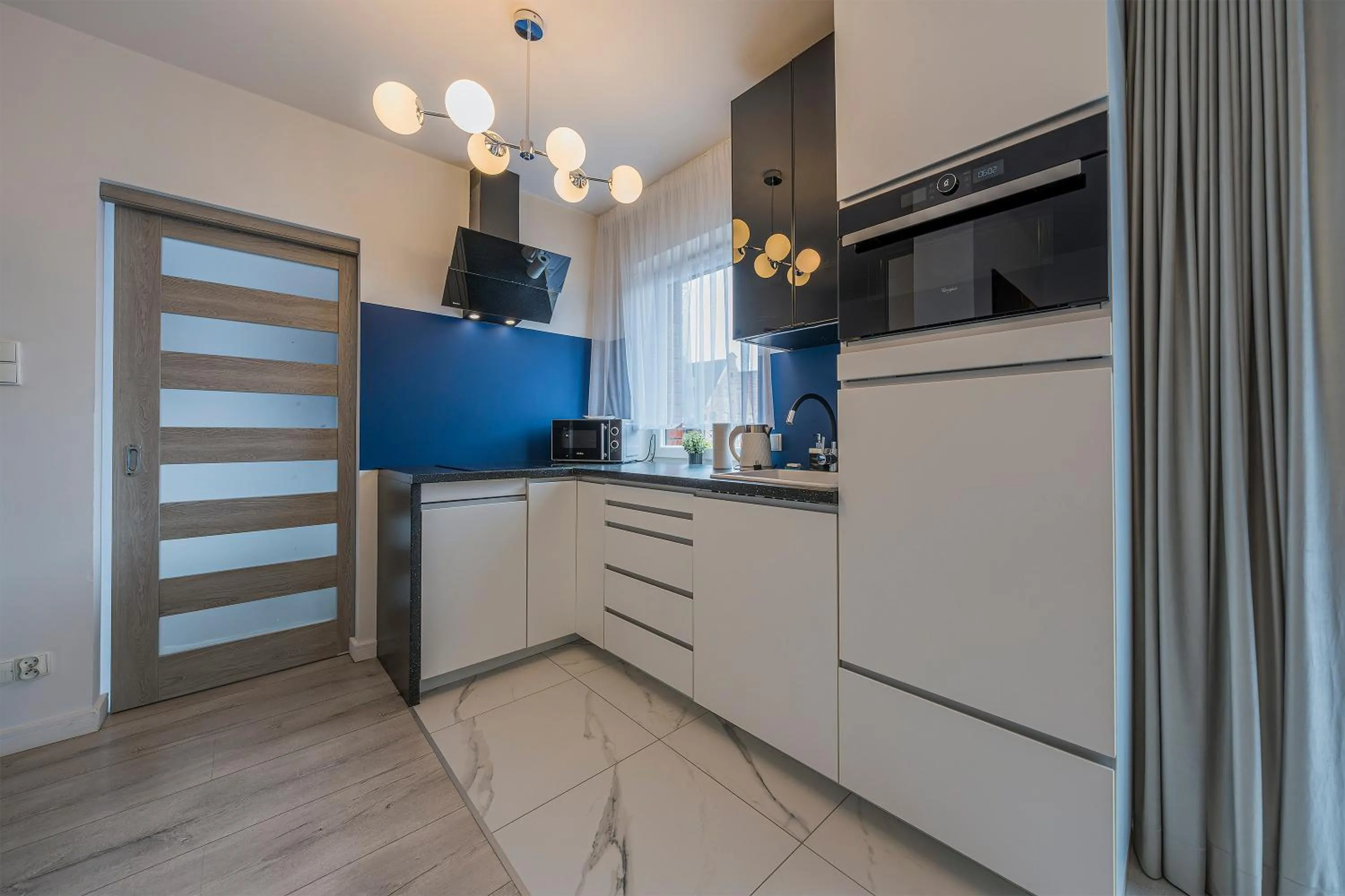 Kitchen or kitchenette in Chmielna Park by Comfort Apartments