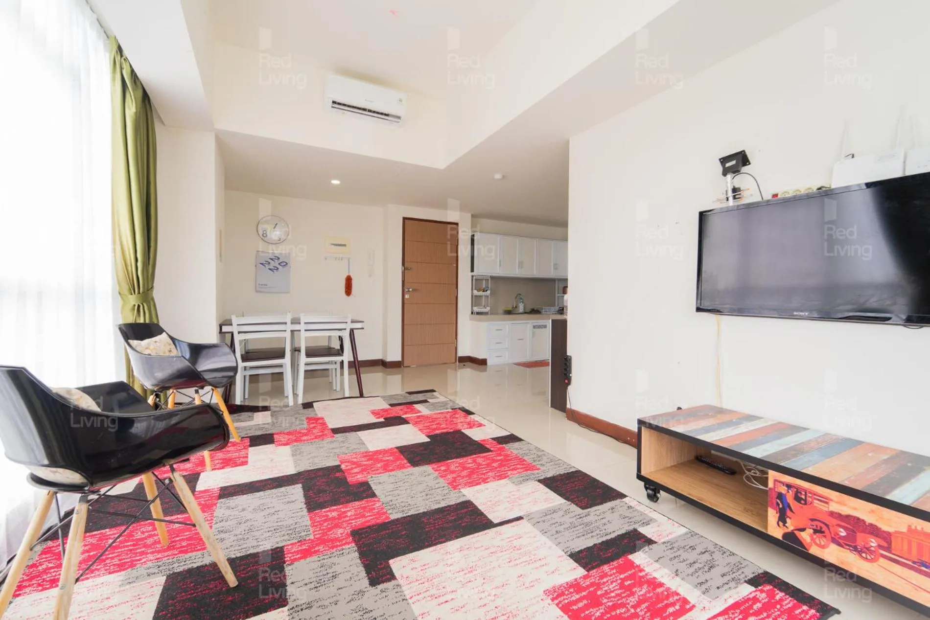 Living room in RedLiving Apartemen Vida View - Vida Connect