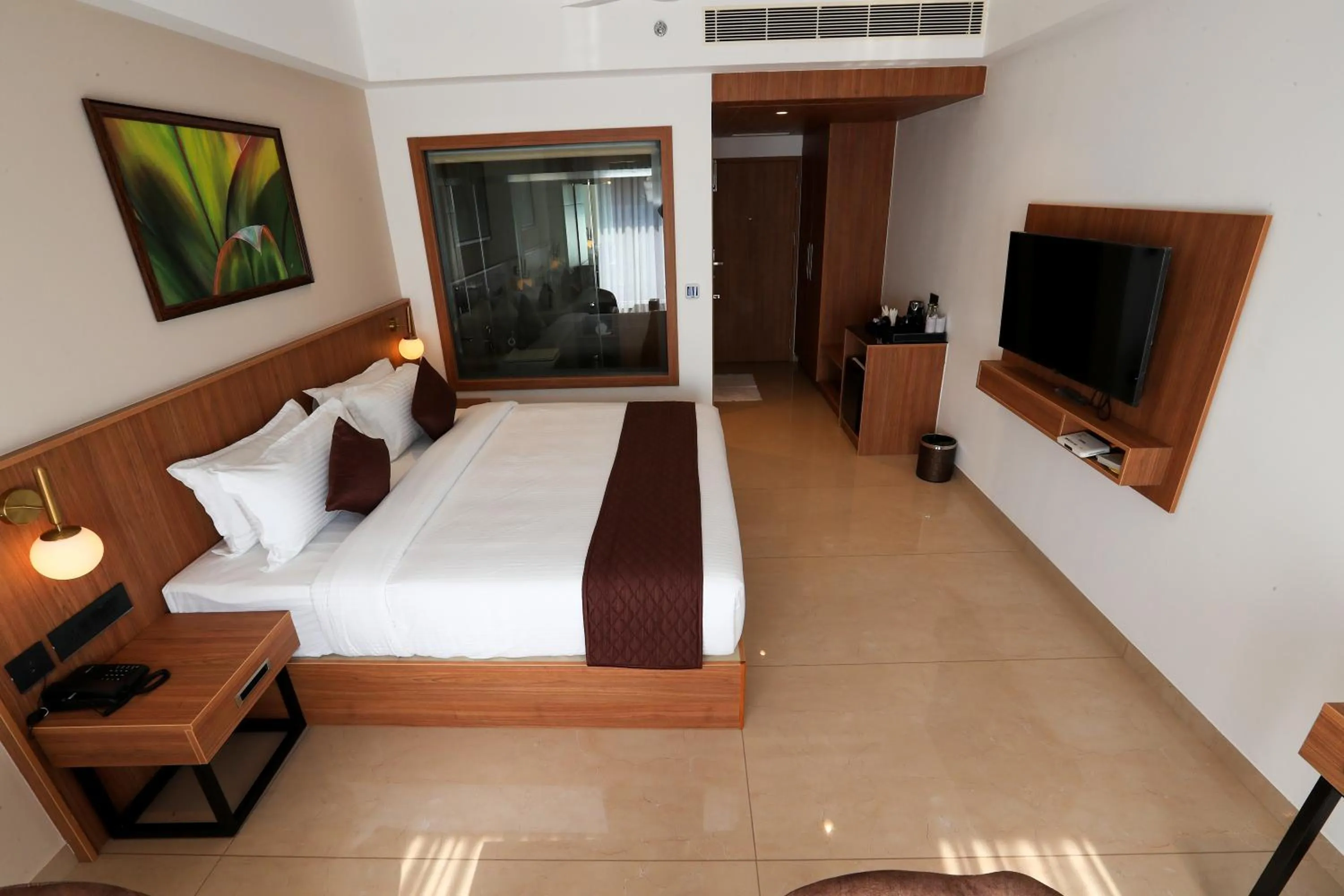 Communal lounge/ TV room, Bed in Hotel Saffron Wayanad