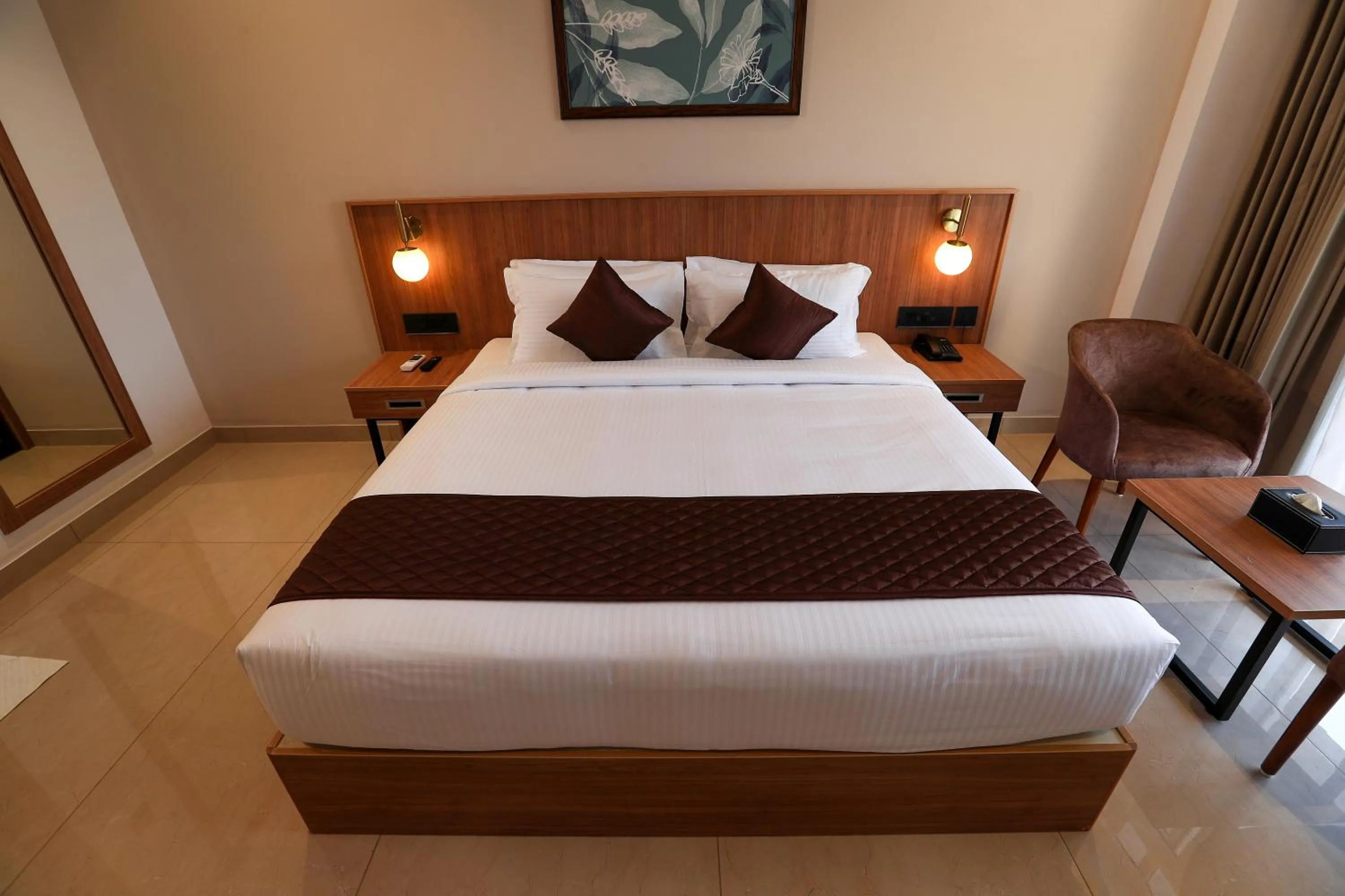 Bed in Hotel Saffron Wayanad