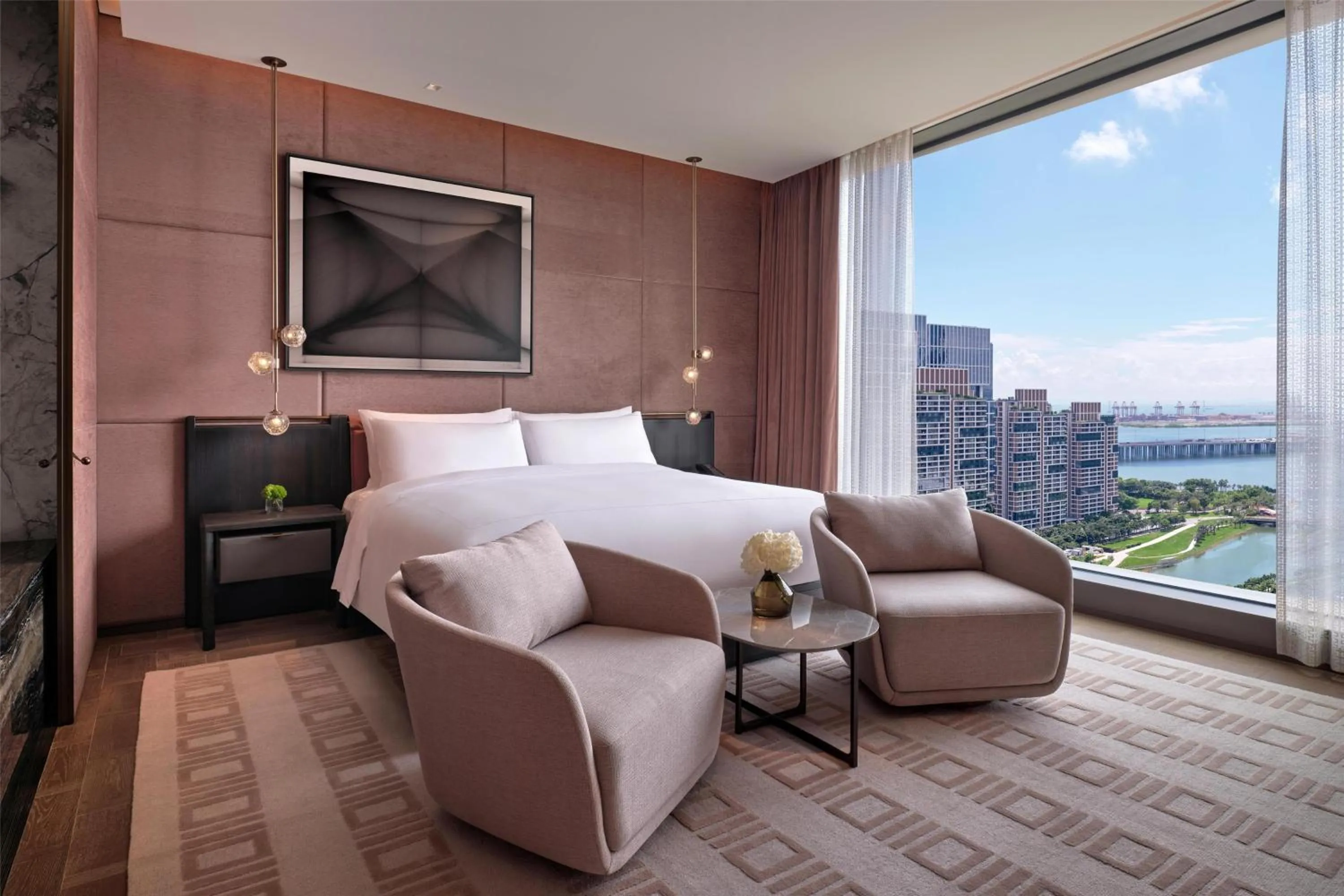 Living room in Conrad Shenzhen, the first art museum hotel in Greater Bay Area with the stunning bay and sunset view in the hotel terrace