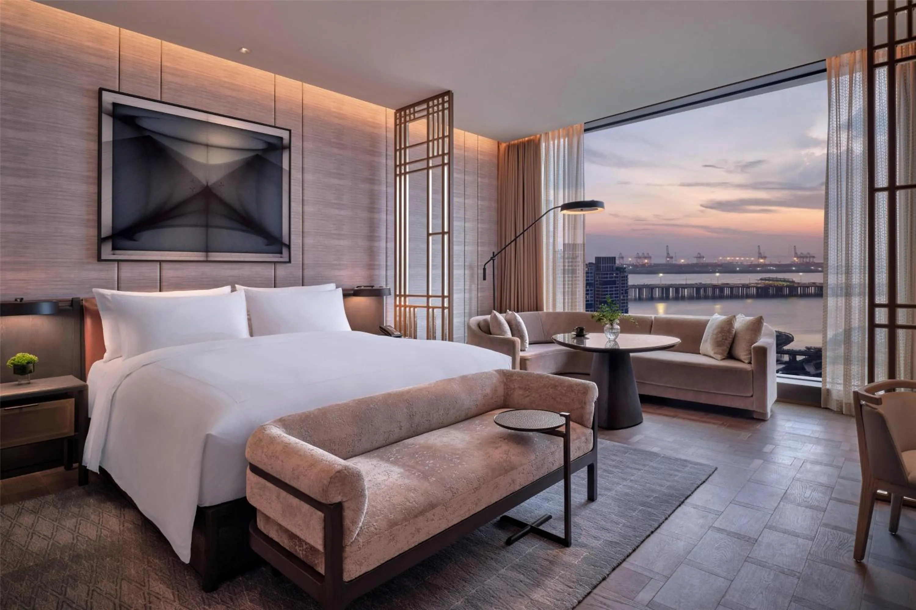 Bed in Conrad Shenzhen, the first art museum hotel in Greater Bay Area with the stunning bay and sunset view in the hotel terrace