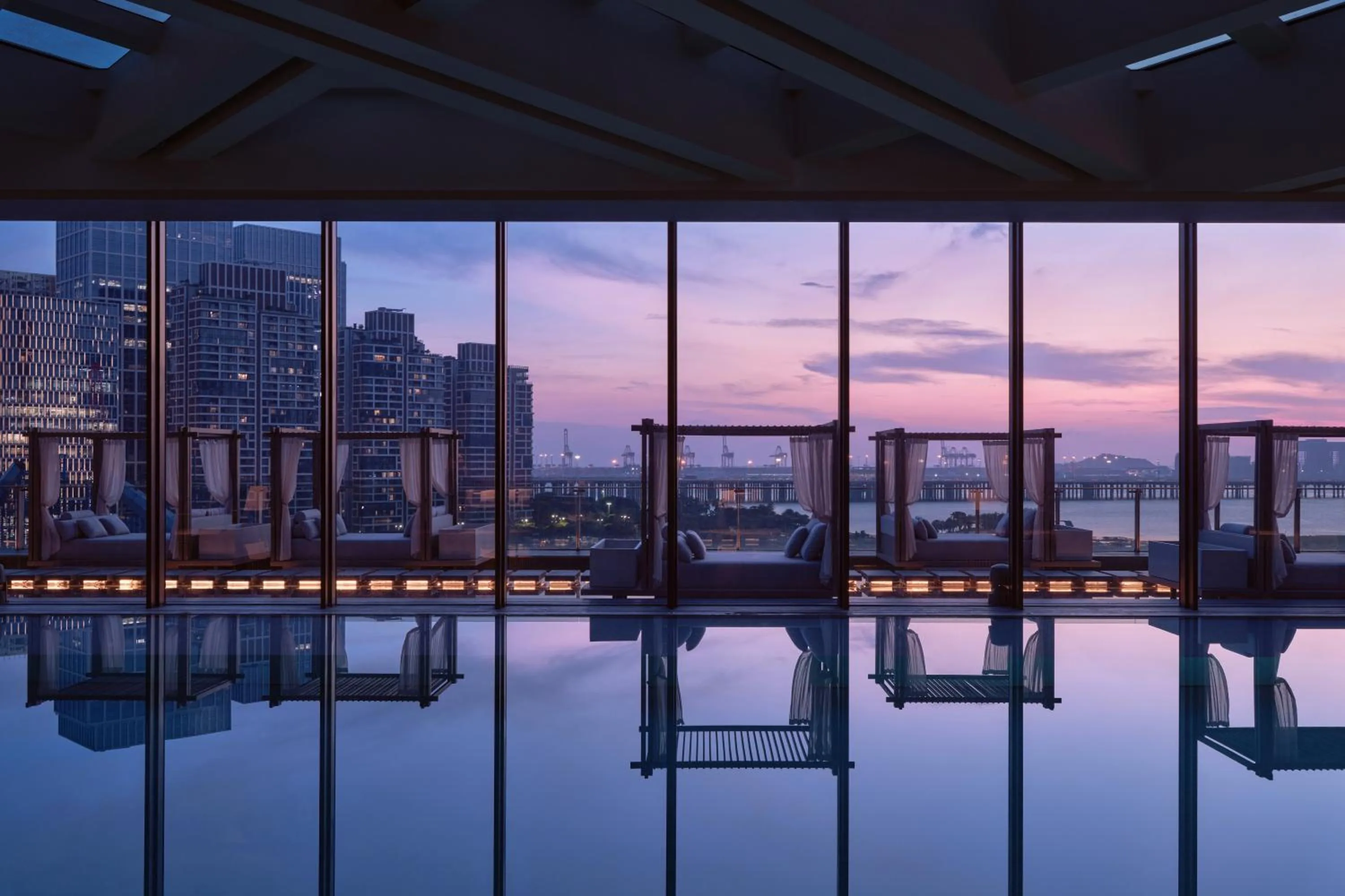 Swimming pool in Conrad Shenzhen, the first art museum hotel in Greater Bay Area with the stunning bay and sunset view in the hotel terrace
