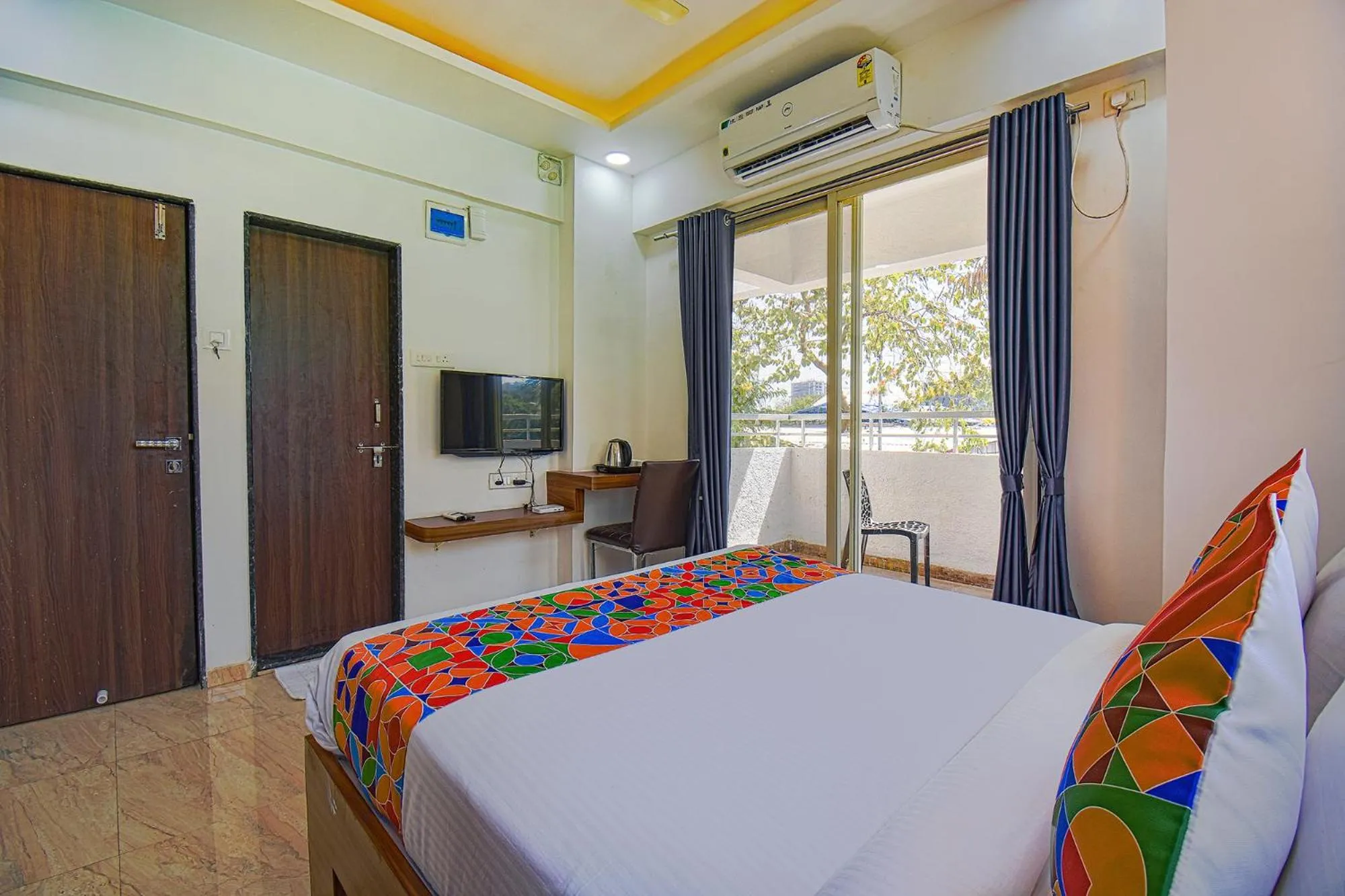 Bed in FabHotel Red Velvet Inn & Suites