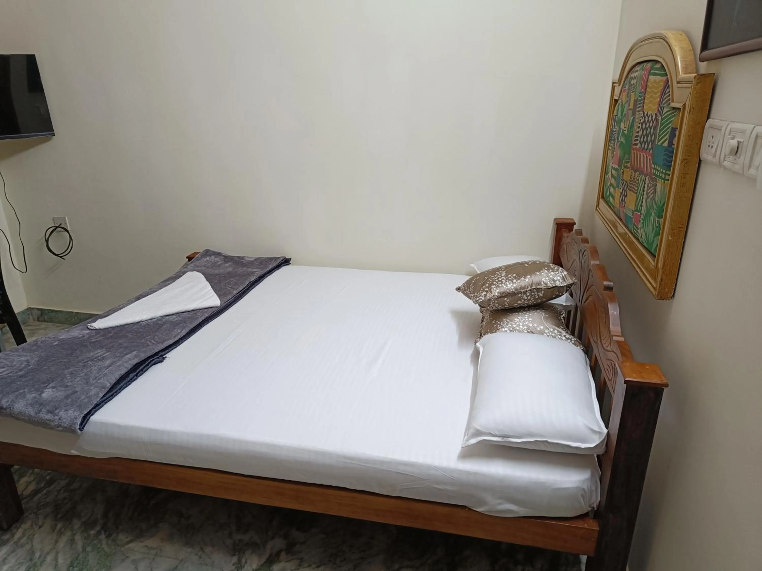 Bed in NALINAM HOMESTAY