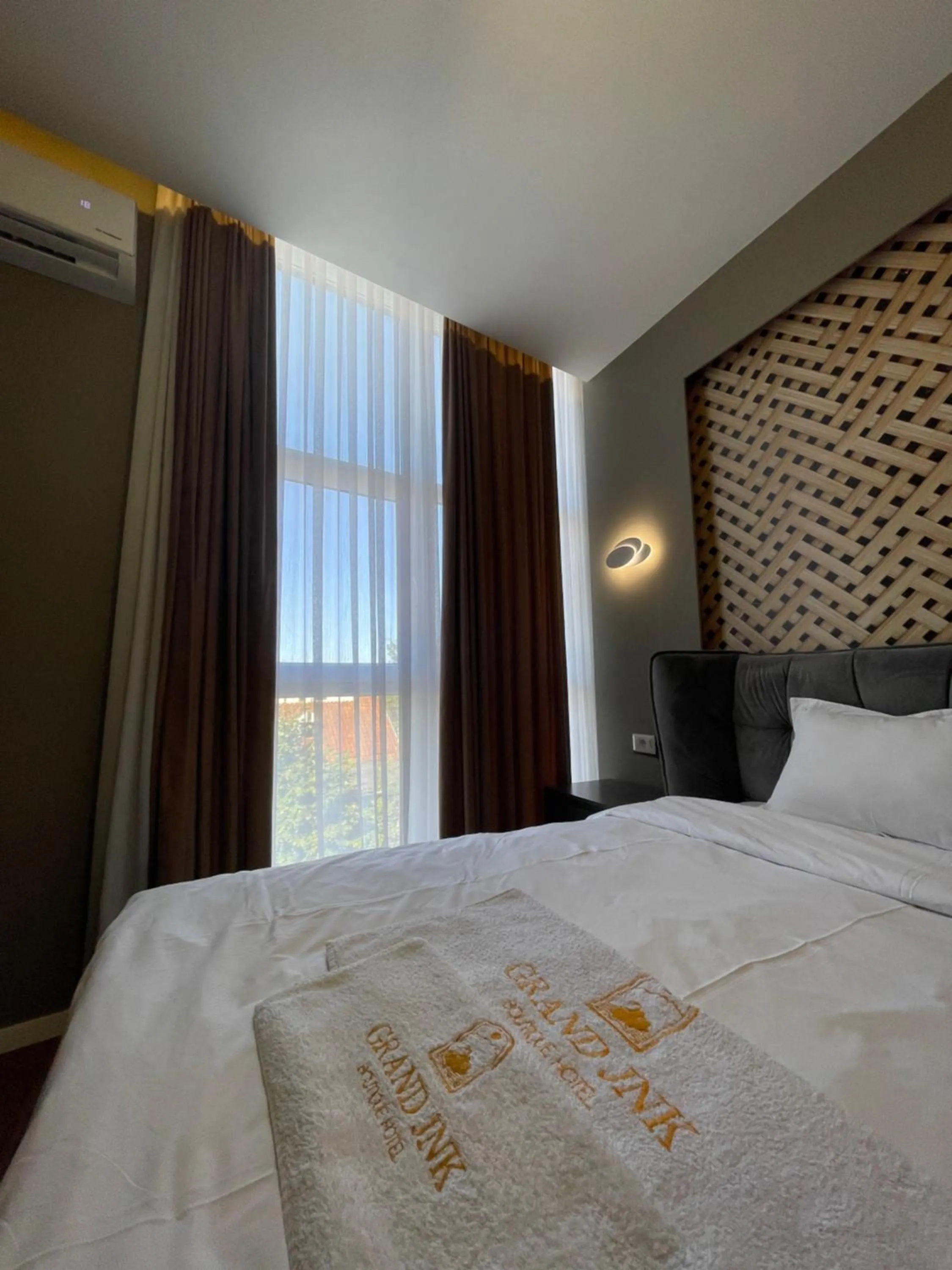 Bed in GRAND JNK Boutique Hotel