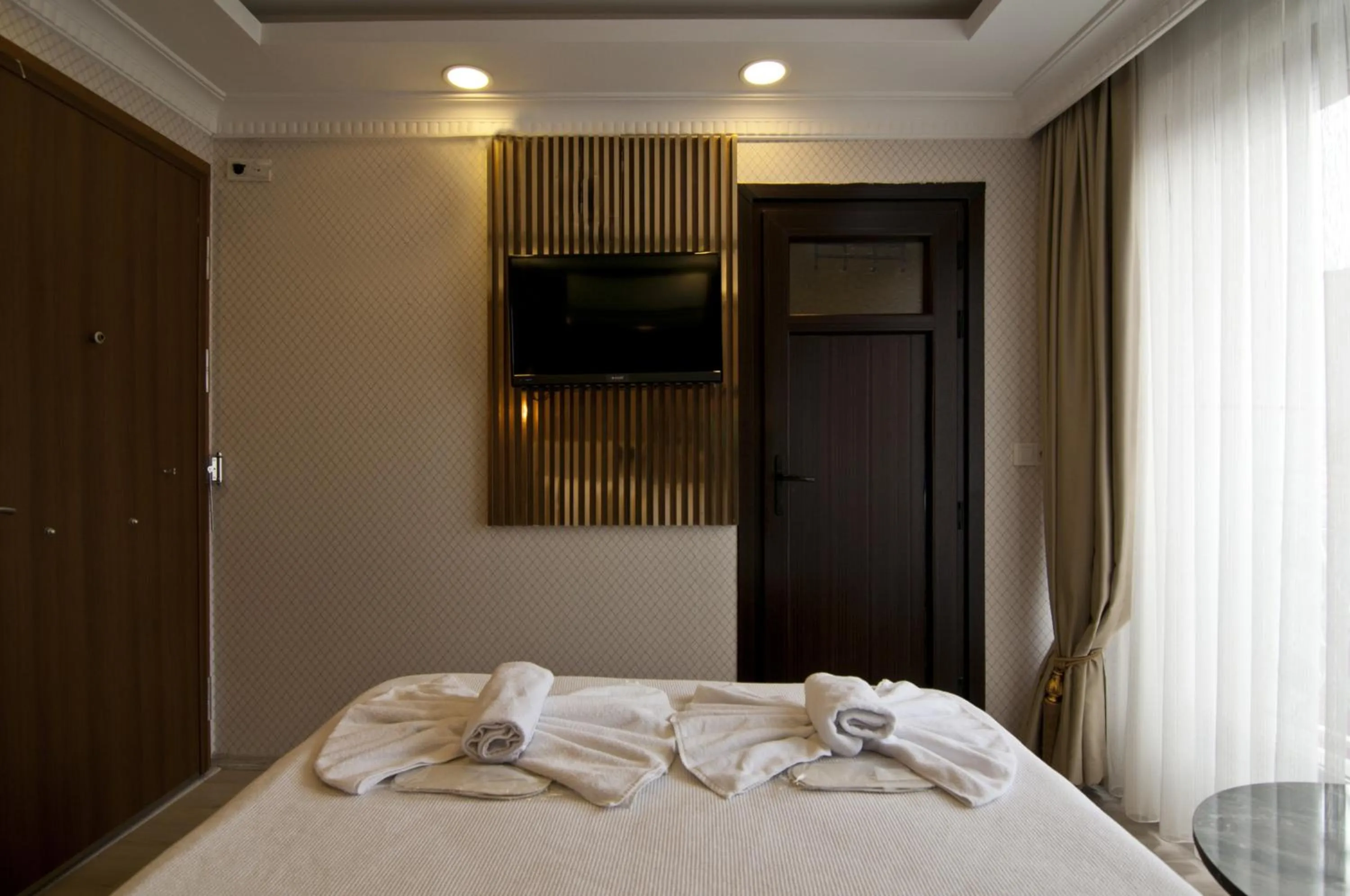 Bed in IMMORTELLE HOTEL