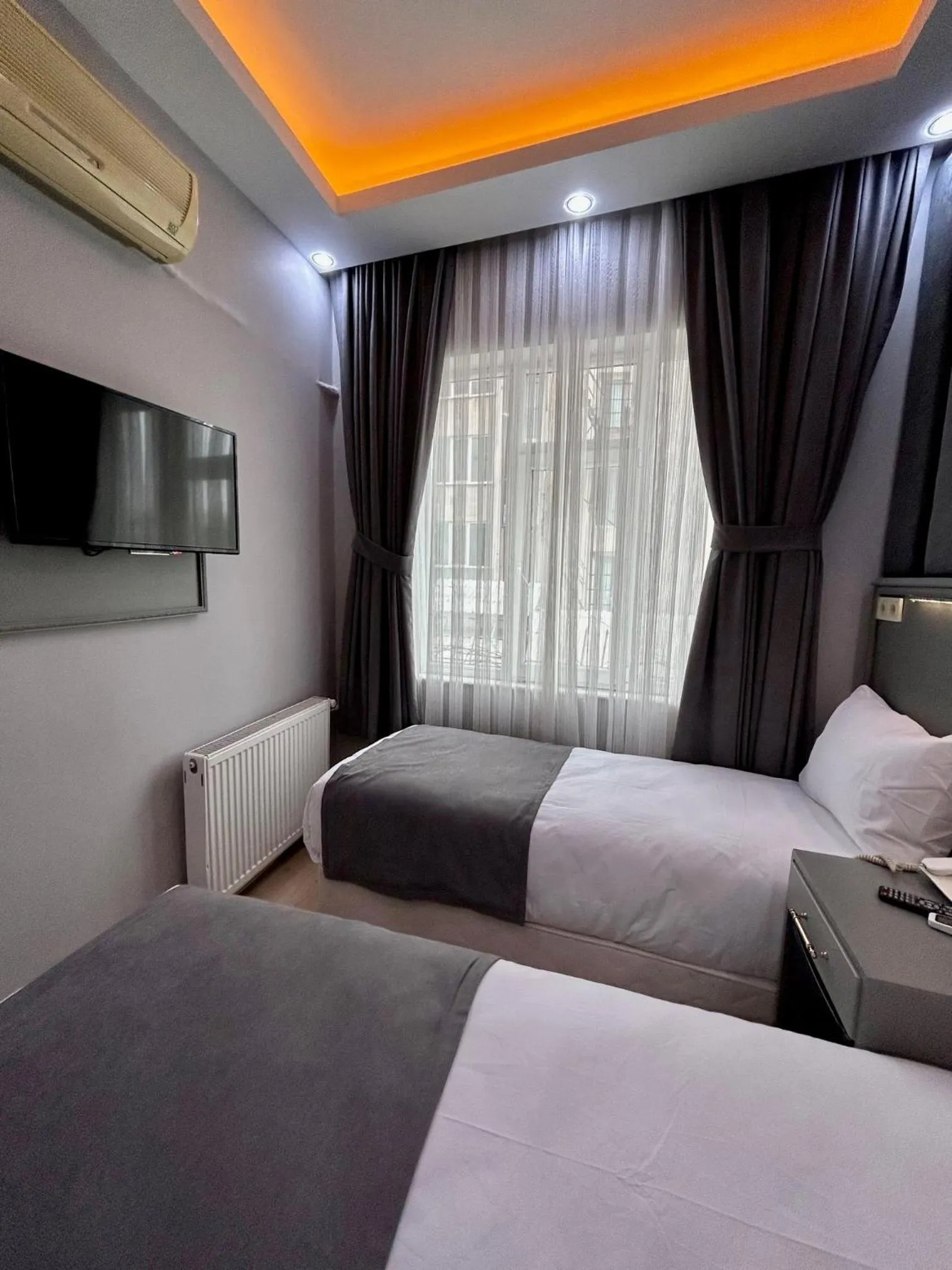 Communal lounge/ TV room, Bed in Crowned Plus Hotel