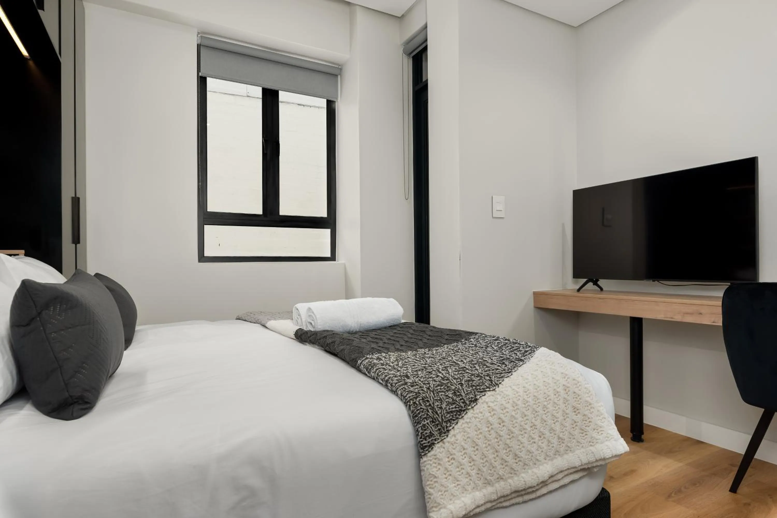 Bed in The Carrington Luxury Apartments
