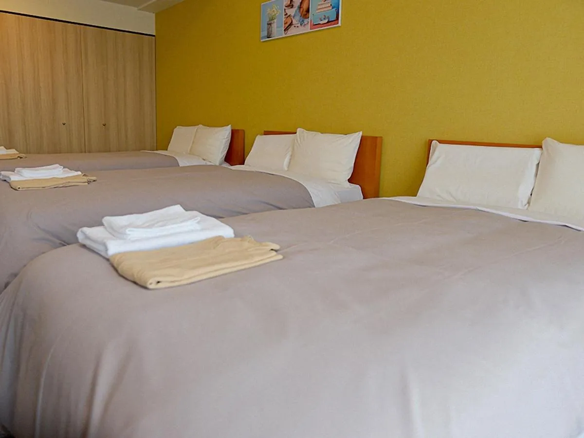 Bed in Jisco Hotel Obama Onsen