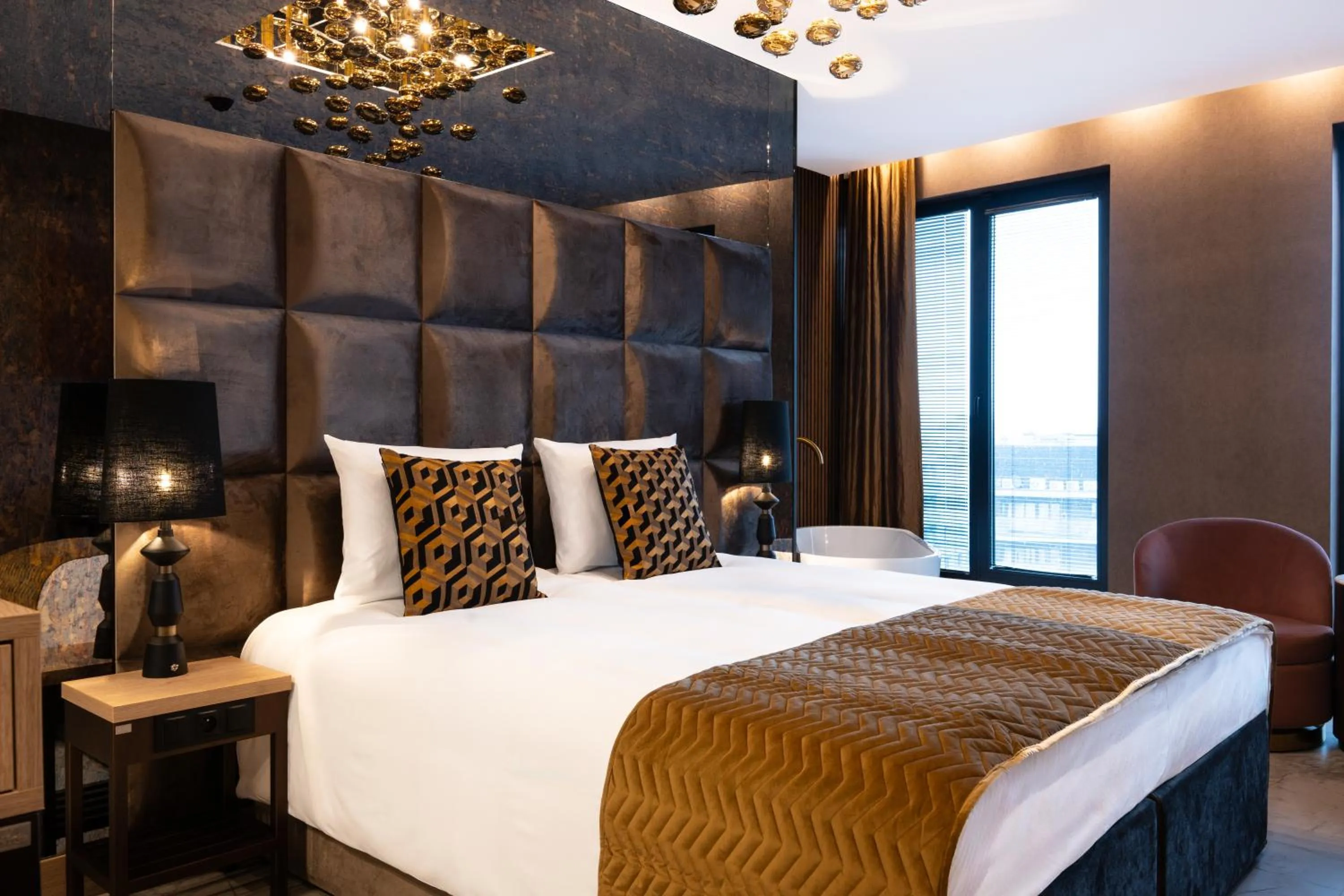 Bed in Art Suites Luxury Hotel