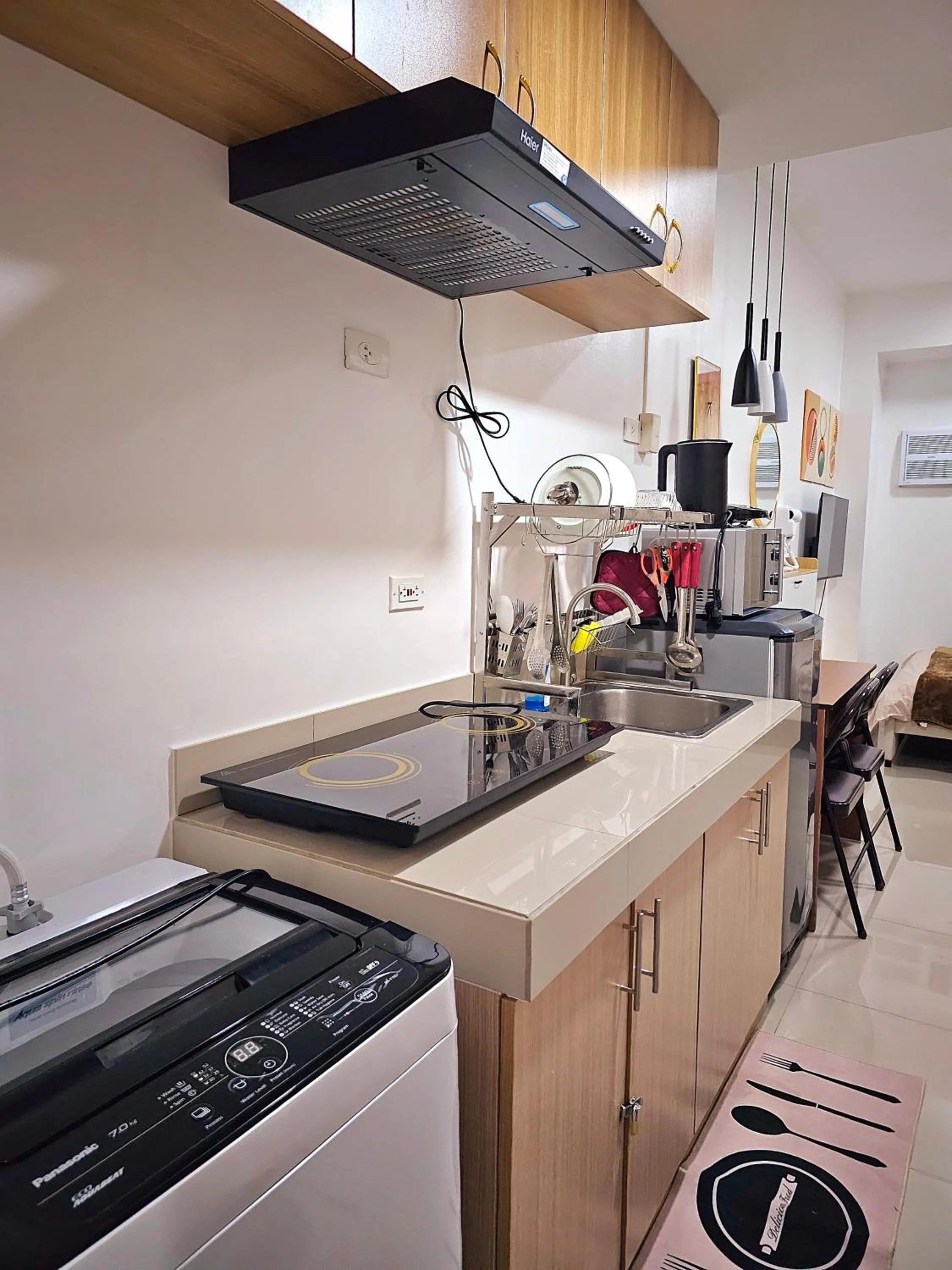 Kitchen or kitchenette in Acellyne's Suites at Green 2 Residences with Netflix!