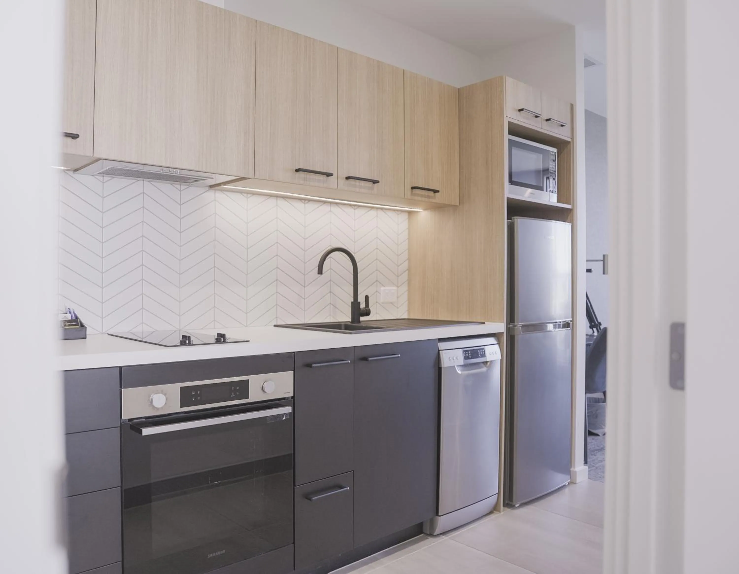 Kitchen or kitchenette in Quest Mt Maunganui